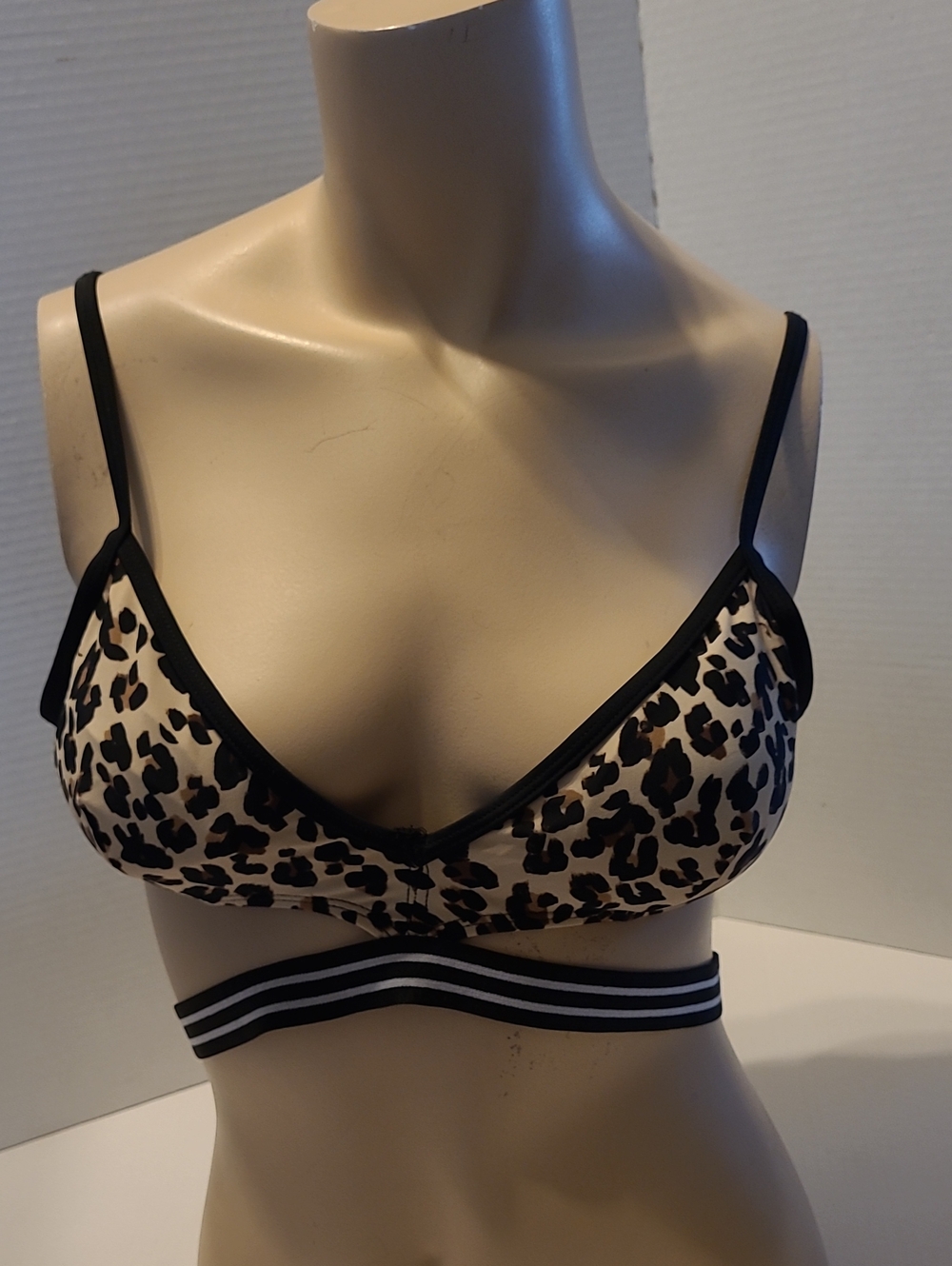 Ardene leopard-print triangle bralette featuring black trim and a double-strap